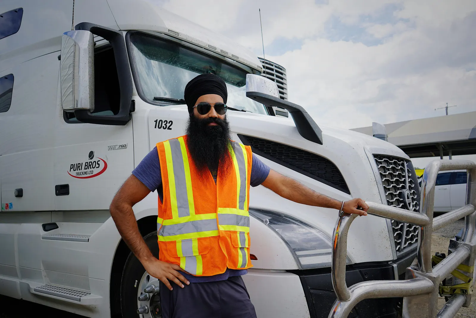 Truck driver standing in front of his semi truck